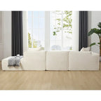 Modern beige L-shaped sectional sofa with tofu block design, large windows, contemporary living room - Elirian