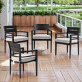 Four black aluminum outdoor dining chairs with cream cushions arranged on wooden deck - Elirian