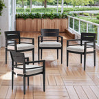Four black aluminum outdoor dining chairs with cream cushions arranged on wooden deck - Elirian