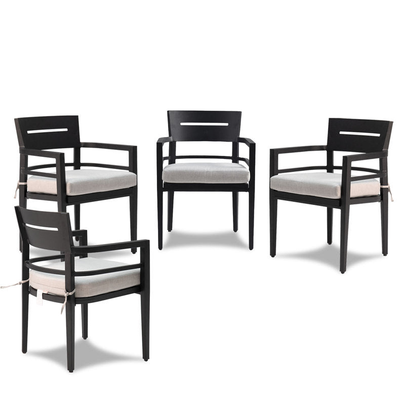 Four black aluminum outdoor dining chairs with cushioned seats arranged in display - Elirian