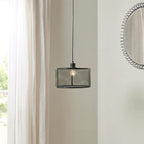 Black drum mesh metal pendant light with adjustable cord above white curtains - Elirian