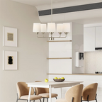 Modern 5-light chandelier with silver finish and frosted glass shades suspended above dining table - Elirian