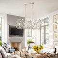 Modern crystal chandelier with vintage silver finish illuminating elegant living room interior - Elirian