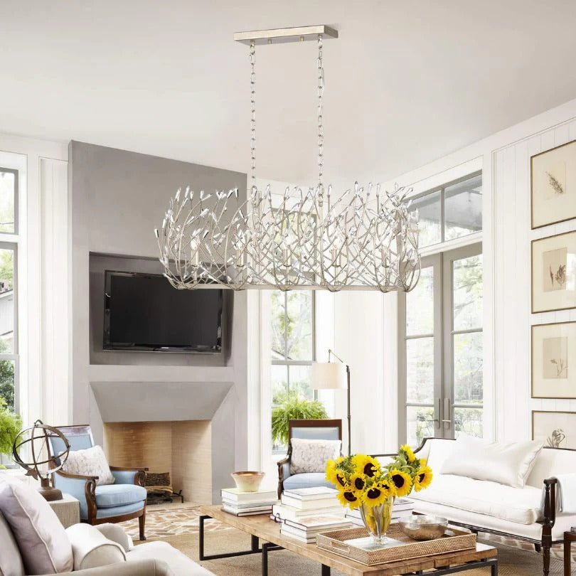 Modern crystal chandelier with vintage silver finish illuminating elegant living room interior - Elirian