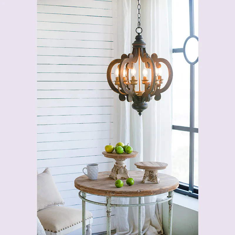 French 6-Light Black Country Wood Pendant Light - Ornate rustic chandelier over round wooden table - Elirian