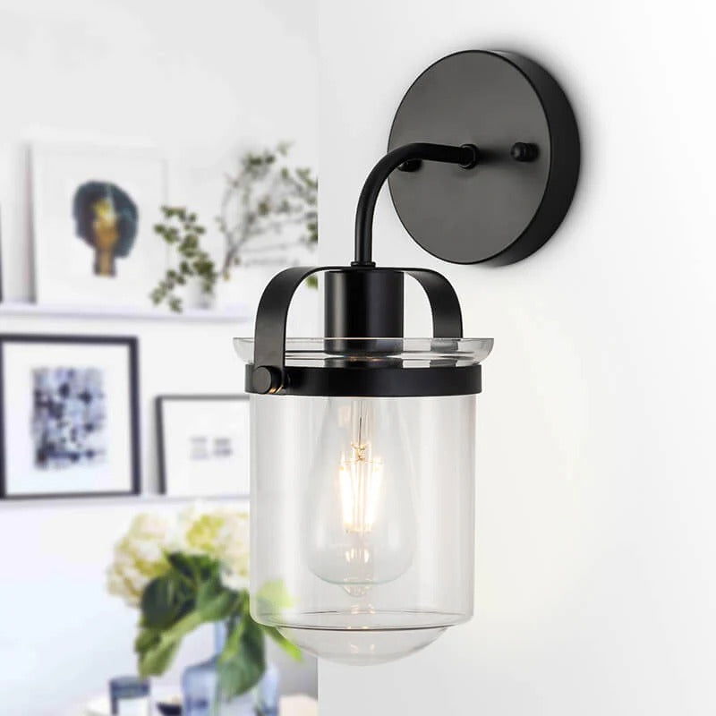 Modern black wall sconce with clear glass shade, contemporary lighting fixture - Elirian