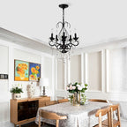 Black crystal chandelier pendant light hanging above wooden dining table in modern kitchen - Elirian