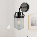 Modern black wall sconce with clear glass shade and adjustable arm - Elirian