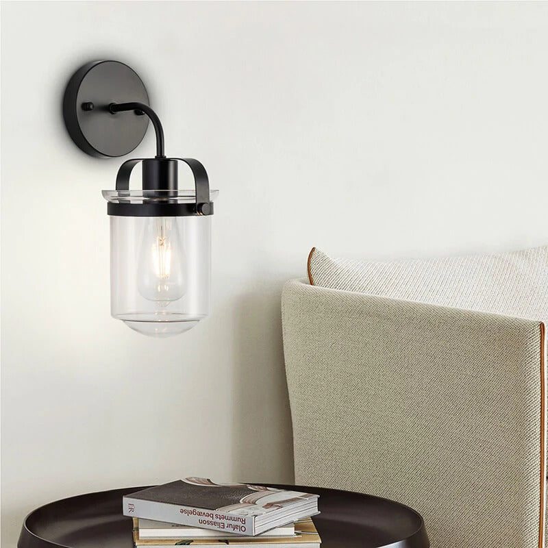 Modern black wall sconce with clear glass shade and chrome accents - Elirian
