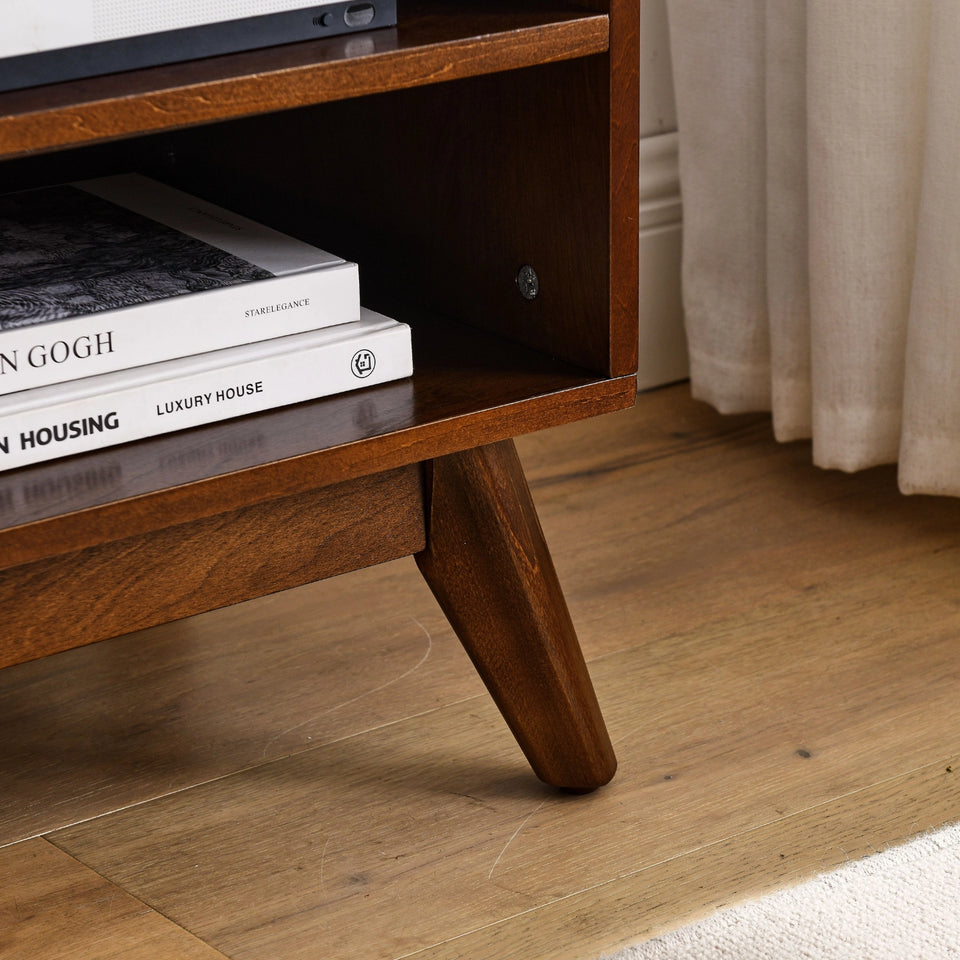 Mid-century modern walnut TV stand with rattan doors displaying books and decor - Elirian